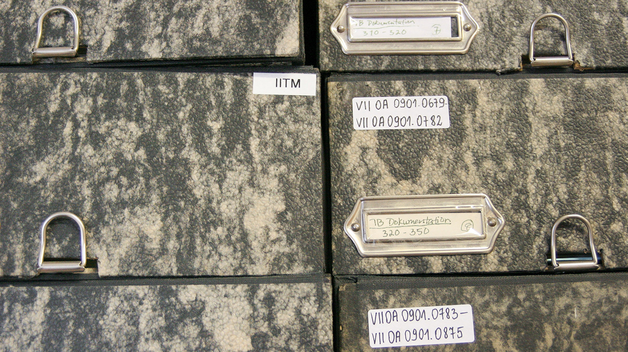 Stack of grey-brown cardboard boxes with labelling