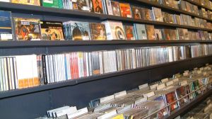 Black shelf rows with CDs