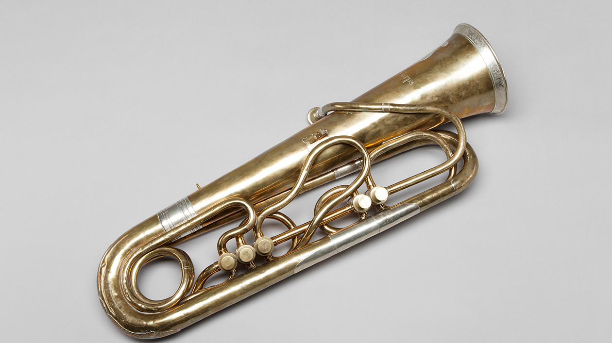 Historic bass tuba on a grey background